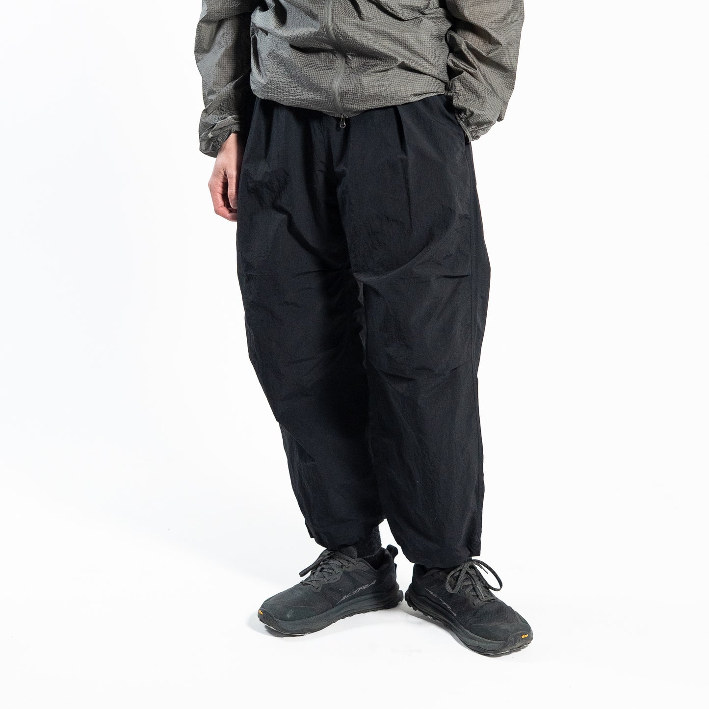 ブラックのワイドトレッキングパンツ（Trail Wide Pants）を着用した男性